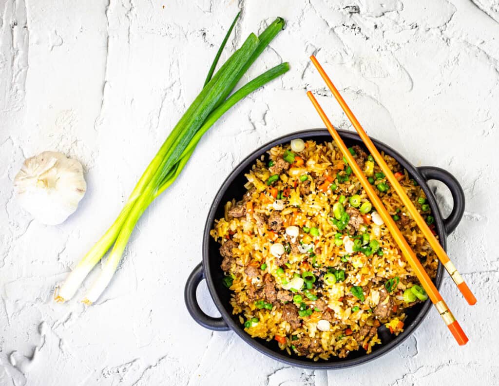 Top-down shot of Ground Beef Fried Rice in a black bowl.