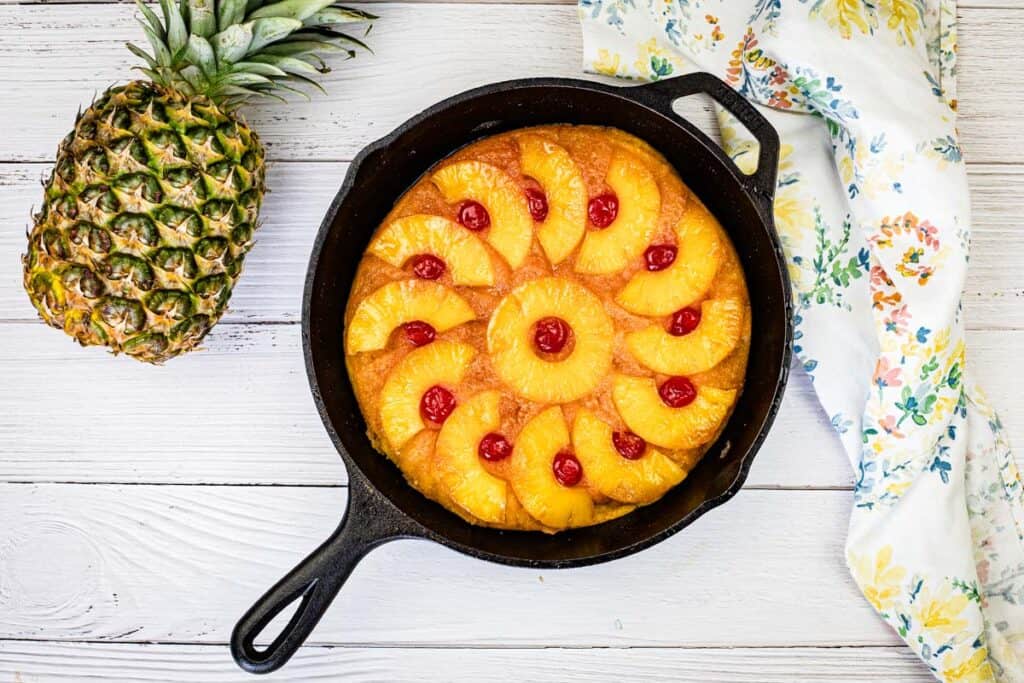 Top-down shot of Pineapple Upside Down Cake beside pineapple.