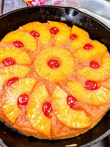 Pineapple Upside Down cake baked in a black cake pan.