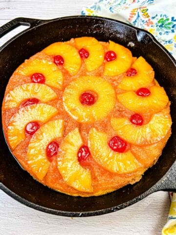 Pineapple Upside Down Cake on a black cake pan.