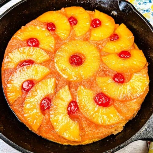 Pineapple Upside Down Cake on a black cake pan.