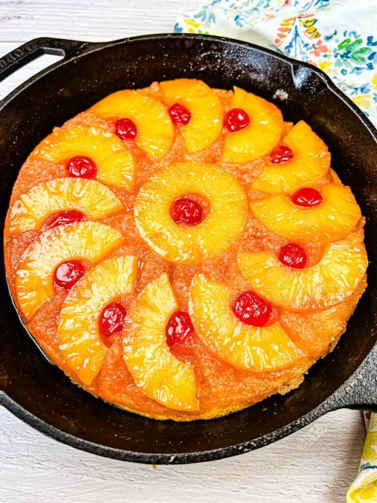 Pineapple Upside Down Cake on a black cake pan.