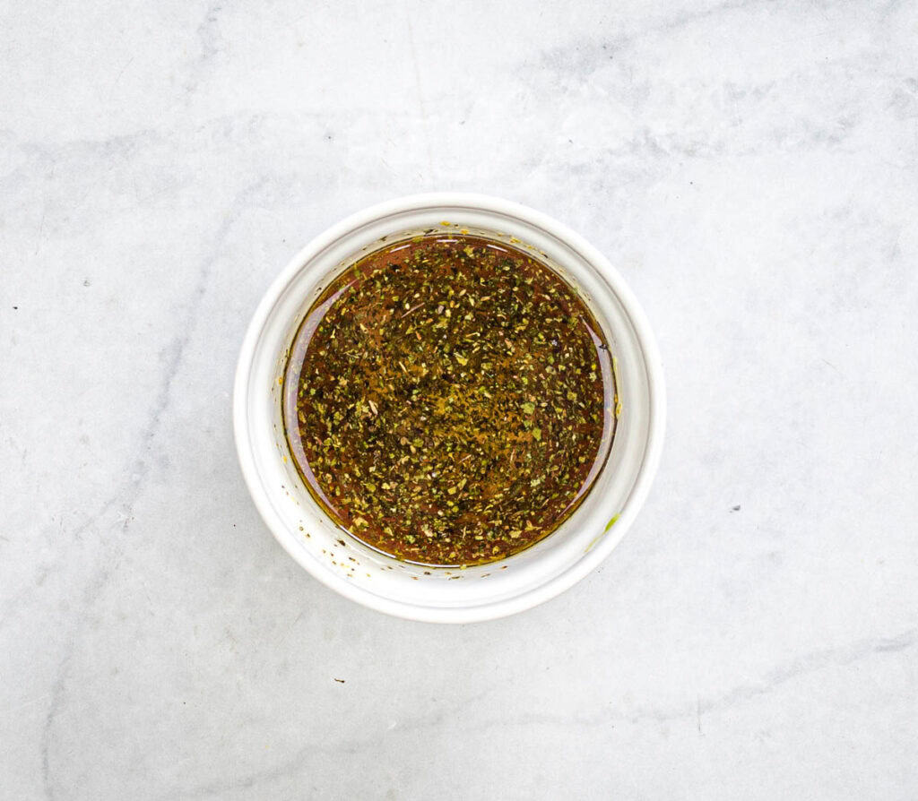 Whisk the olive oil, red wine vinegar, and oregano in a small bowl.