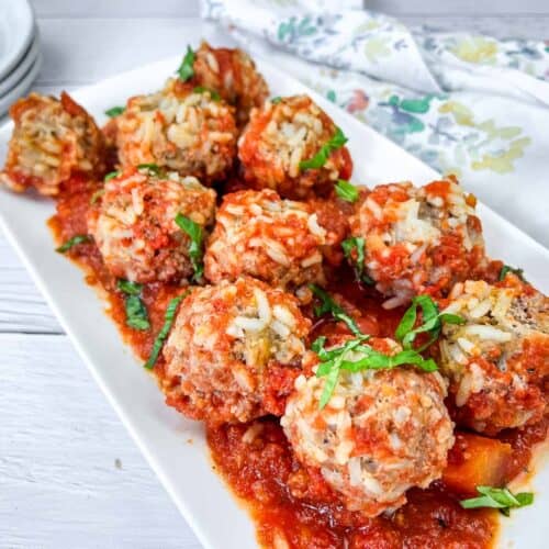 Then pieces of Slow Cooker Porcupine Meatballs on a white plate.