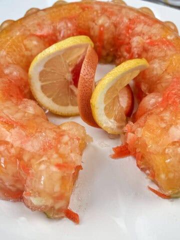 Sunshine Salad with orange slices in the center on a white plate.