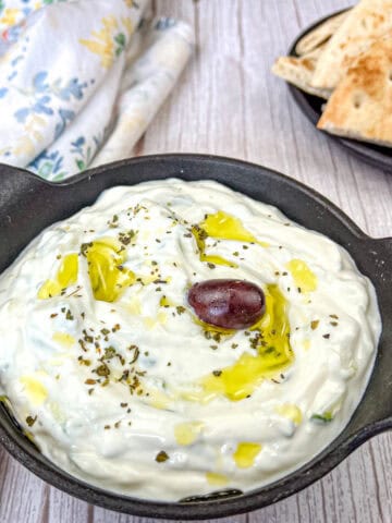 Tzatziki Sauce on a black bowl.