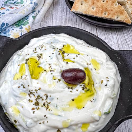 Tzatziki Sauce on a black bowl.