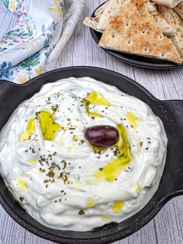 Tzatziki Sauce on a black bowl.