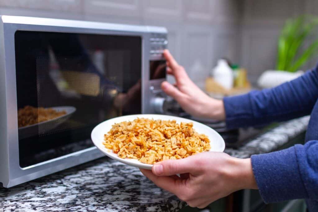 Using a microwave to warm a plate.