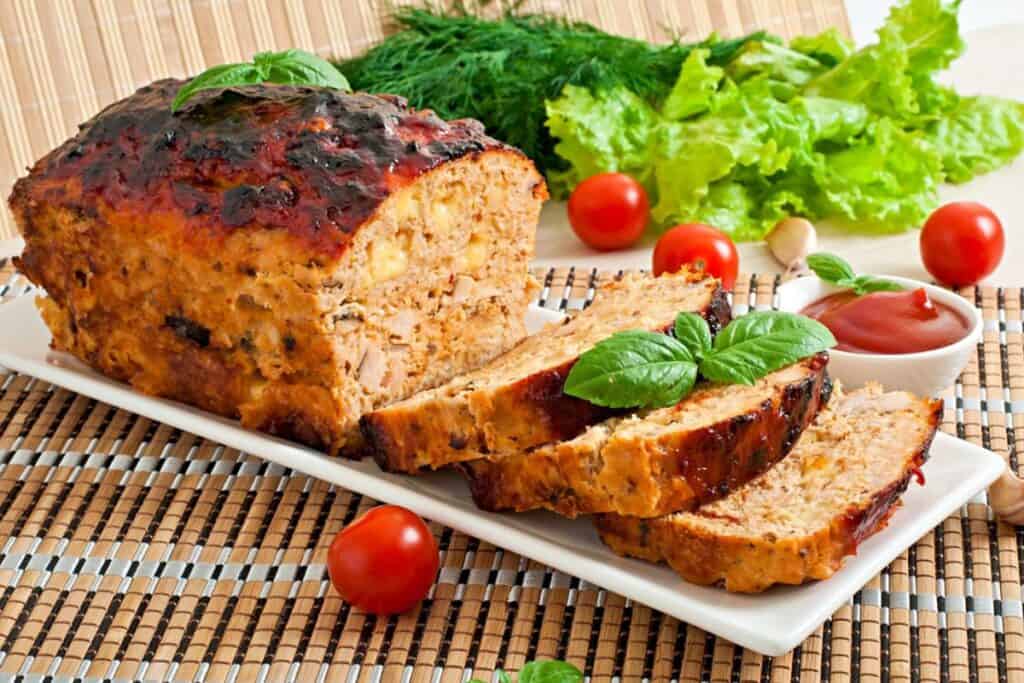 Meatloaf with ketchup and basil.