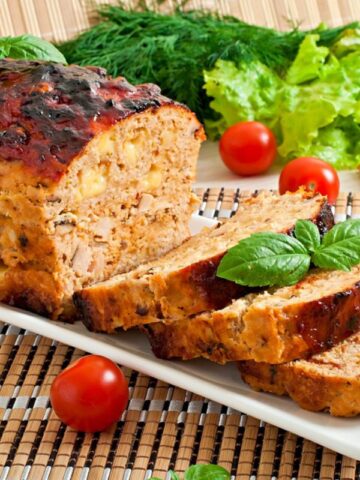 Meatloaf with ketchup and basil.