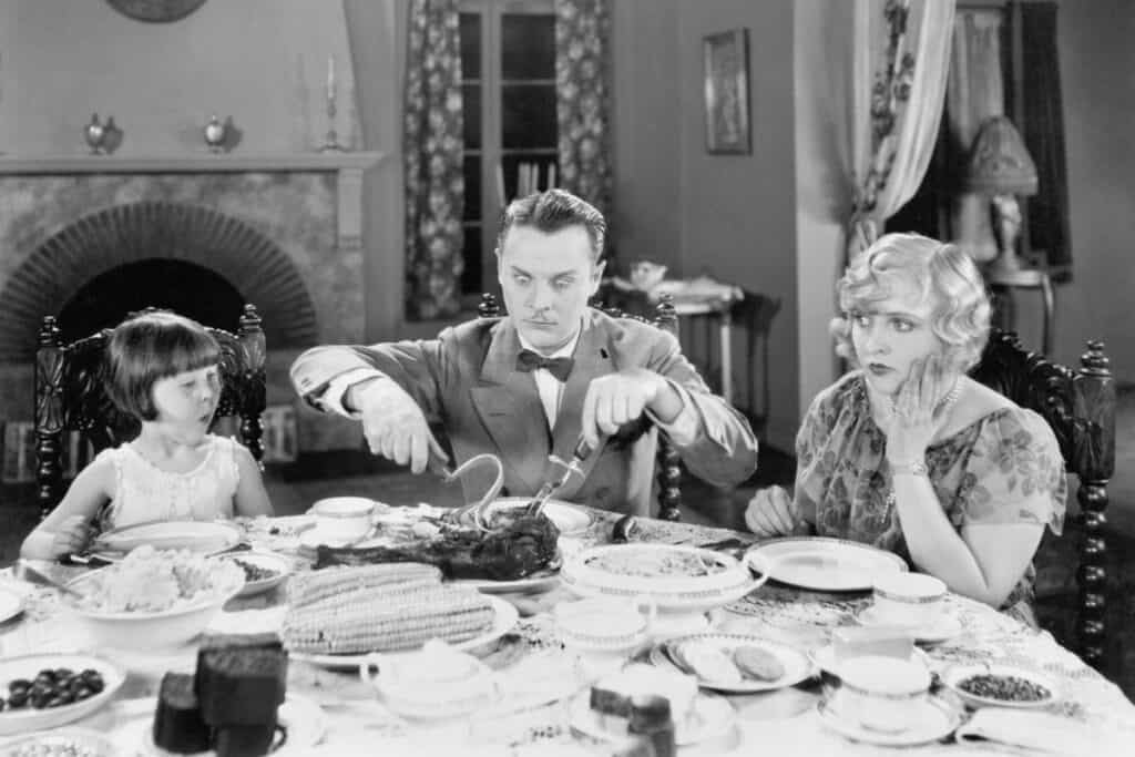 Family of three sitting together having dinner.