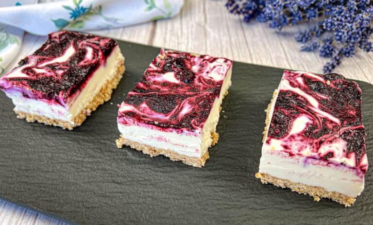 No-bake blueberry cheesecake bars on a slate plate.