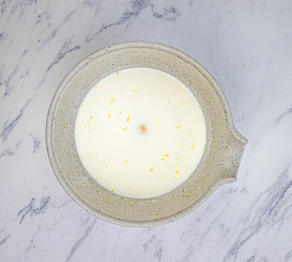 Mix milk, all but 1 tablespoon of heavy cream, and egg yolk in a small bowl.