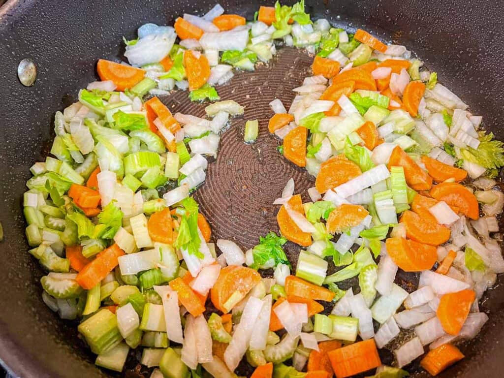 Add the diced onion, celery, and carrot to the remaining fat.