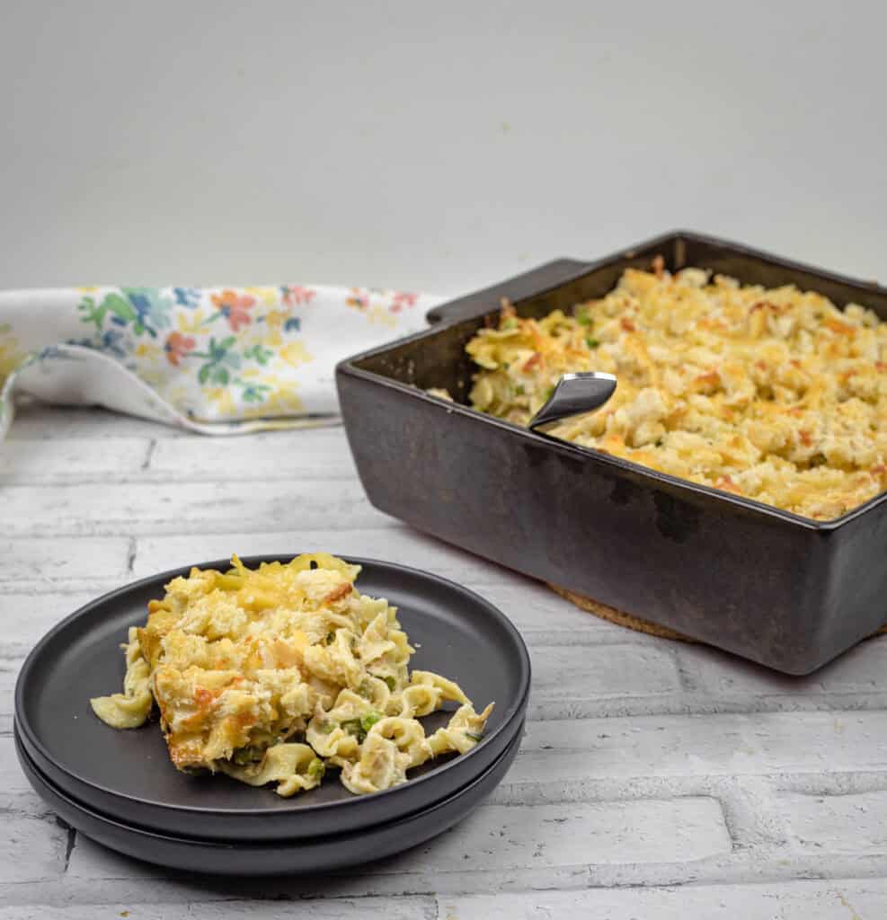 Classic Tuna Noodle Casserole on a tray and black plate.