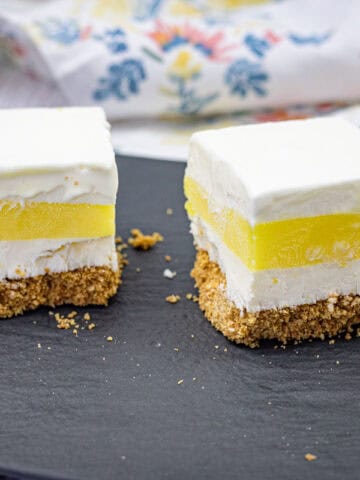 Close-up pieces of lemon lush on a slate plate.