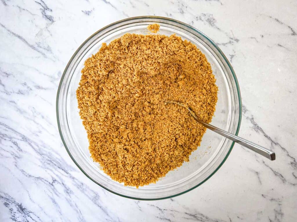 Stir graham crackers and melted butter in a large bowl.