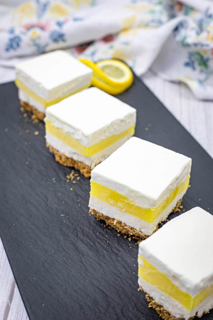 Pieces of lemon lush on a slate plate.