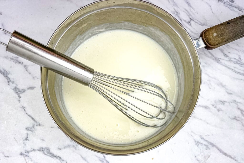 Stream the milk into the butter and flour slowly.