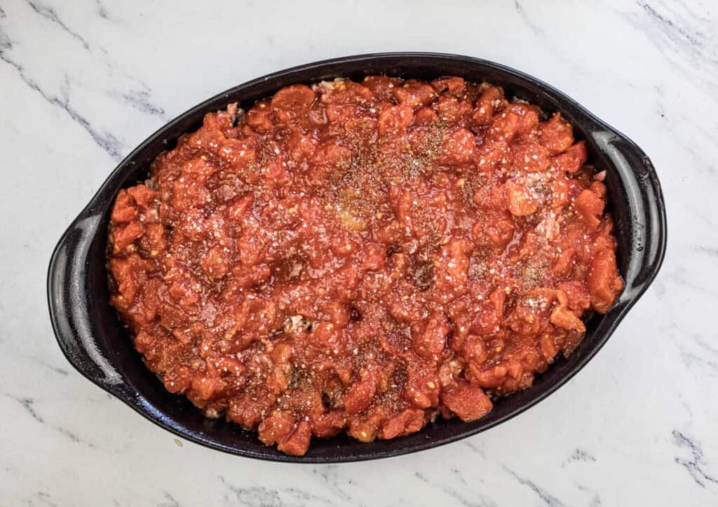 Spoon the tomatoes over the top, and sprinkle with the garlic salt, onion powder, oregano, and celery seed.