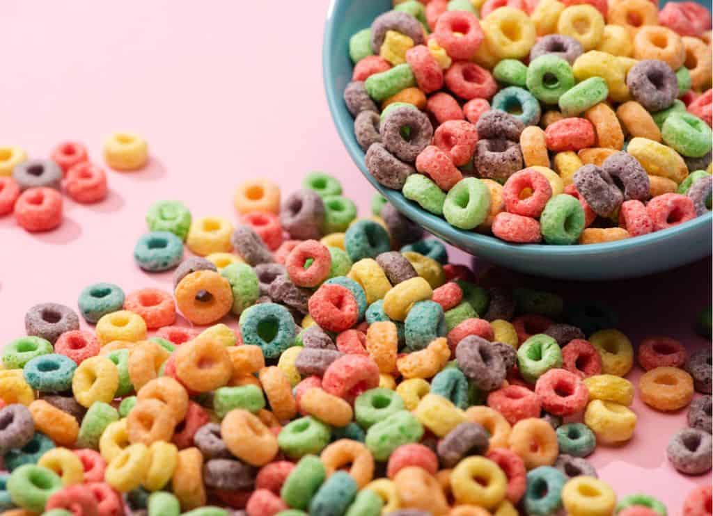 Bright colorful breakfast cereal scattered from bowl.