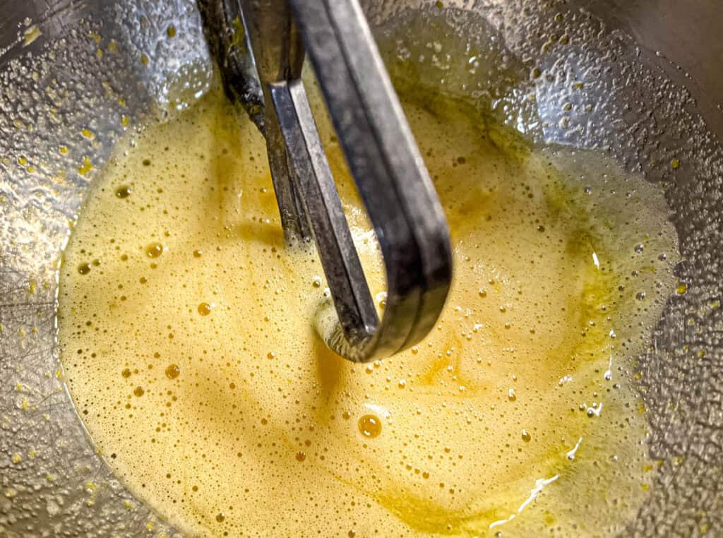 Combine sugar and eggs with an electric mixer.