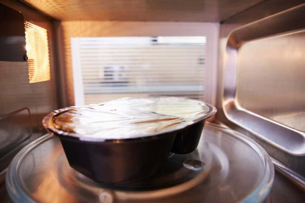 Tv dinner inside a microwave.