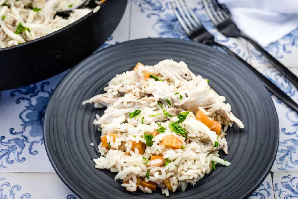 Chicken bog served on a black plate.