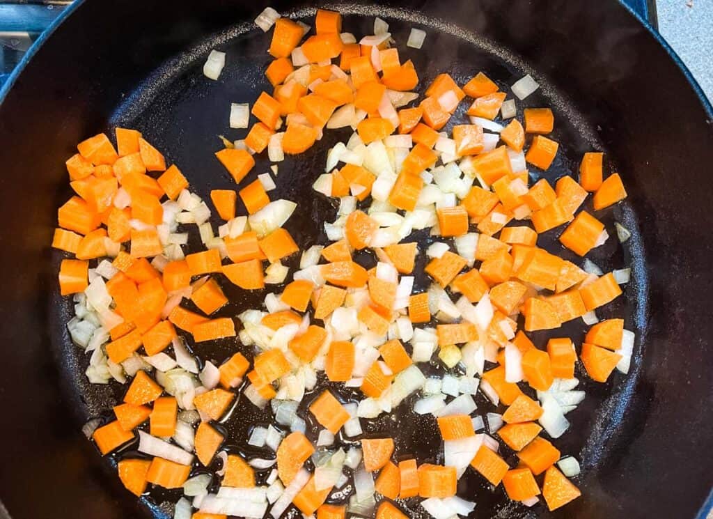 Add the diced onion and carrots to the pot.