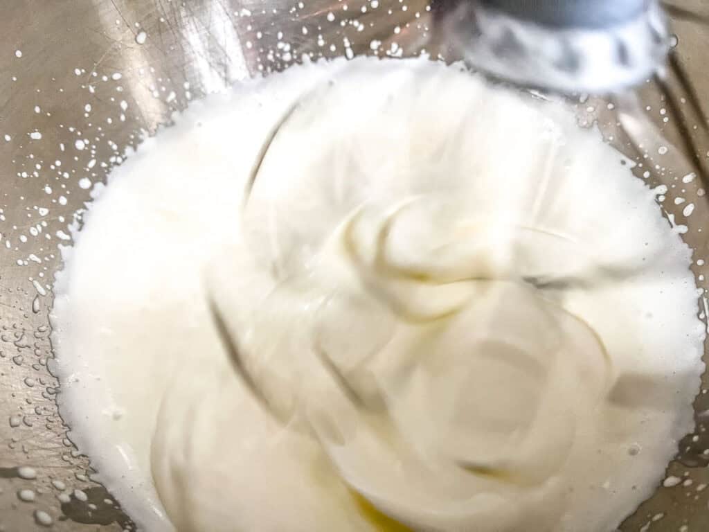 Whip the heavy whipping cream in a large bowl with an electric hand mixer.