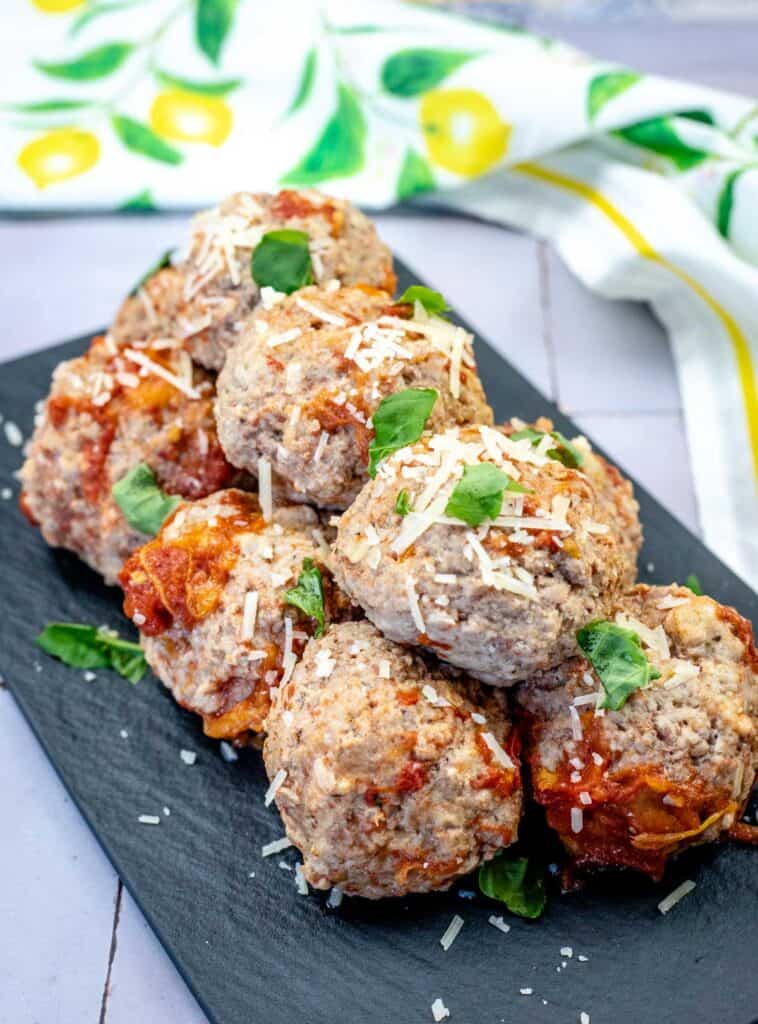 A pile of classic meatballs on a slate plate.