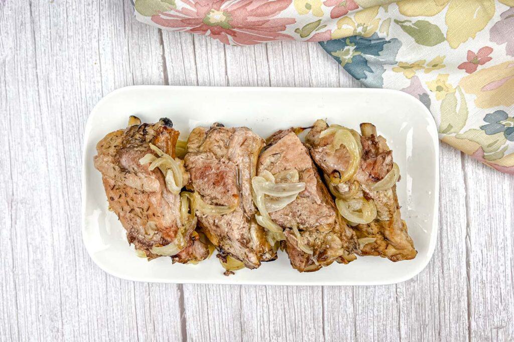 Top-down of Old Fashioned Baked Ribs on a white plate.