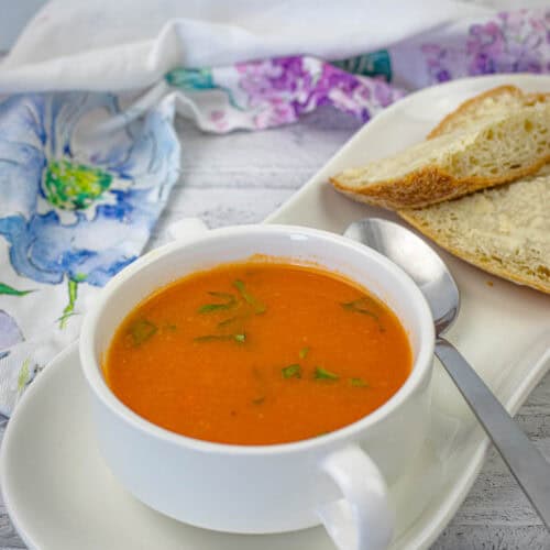 Old Fashioned Tomato Soup with a fresh basil on top.