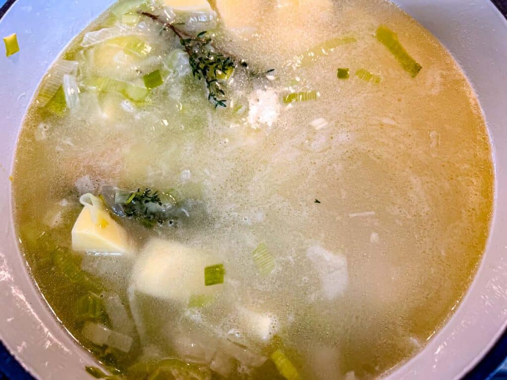 Add water and chicken base, stirring until dissolved.