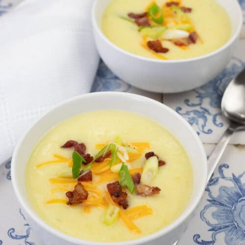 Two bowls filled with Copycat La Madeleine Country Potato Soup.