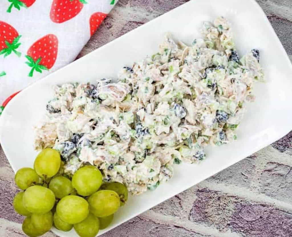 Turkey Salad with Cranberries & Walnuts on a white rectangular plate.