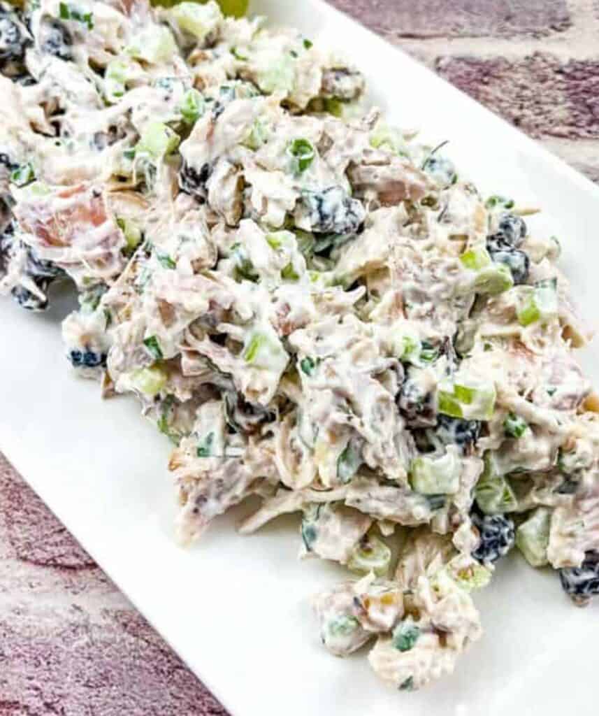Turkey Salad with Cranberries & Walnuts on a white plate.
