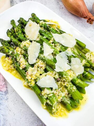 Asparagus with Lemon and Parmesan on a white platter.
