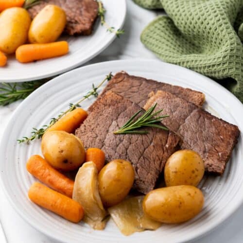 Crockpot slow cooker rump roast on a white plate.