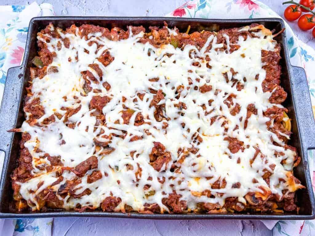 Spaghetti with meat and cheese in a baking dish