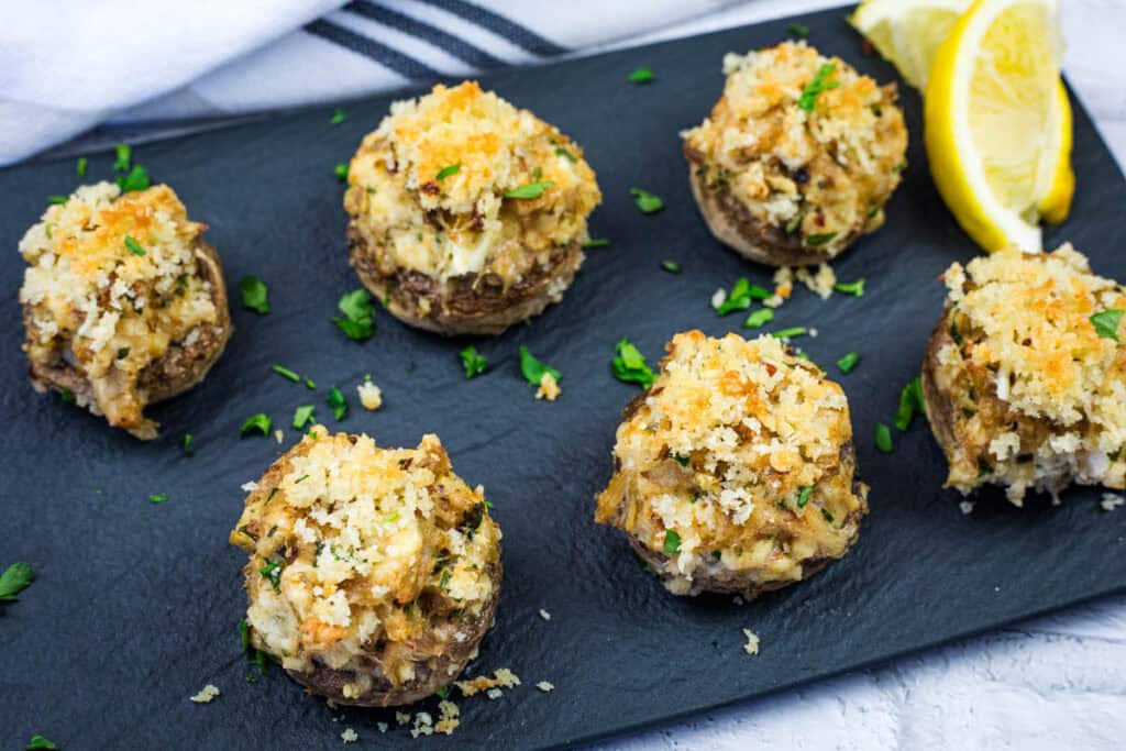 Crab Stuffed Mushrooms on a slate plate.