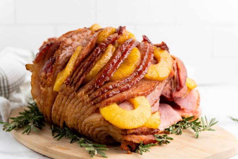 Brown sugar pineapple ham on a wooden platter.