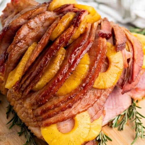 Brown sugar pineapple ham on a wooden platter.