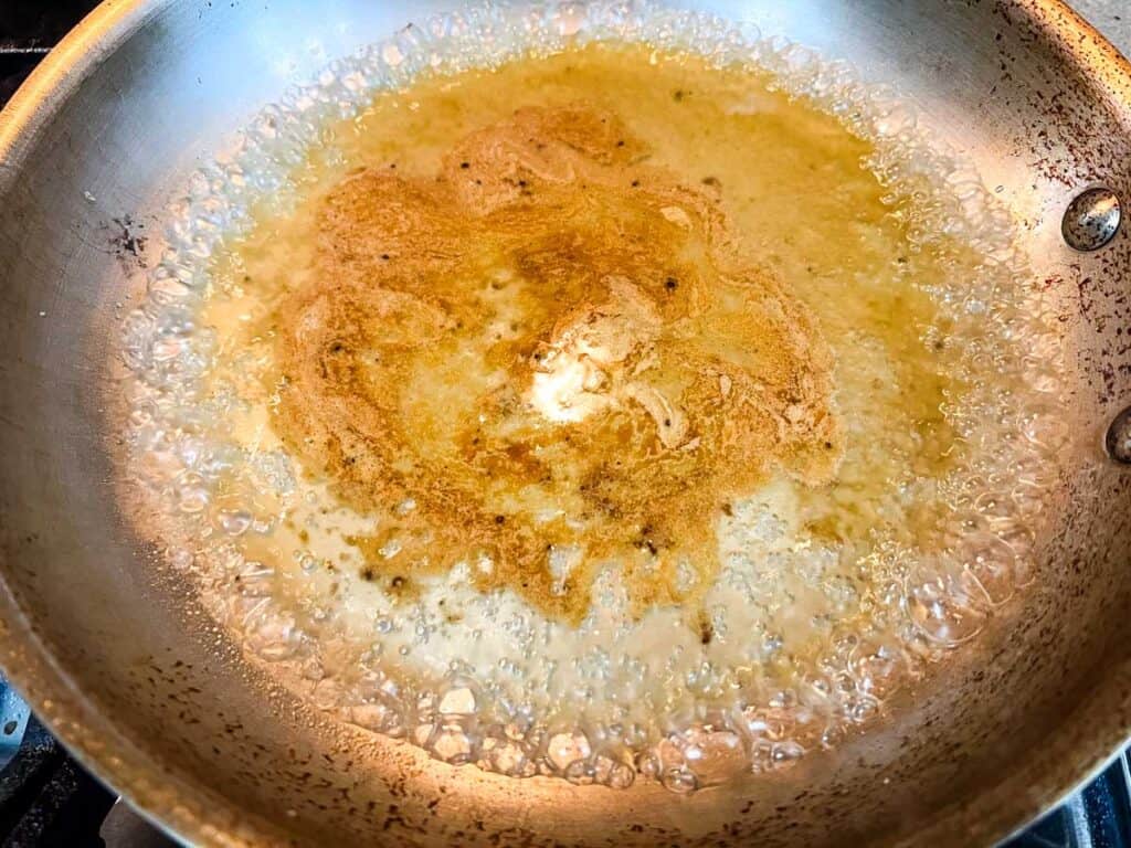 White wine and chicken broth in a skillet.