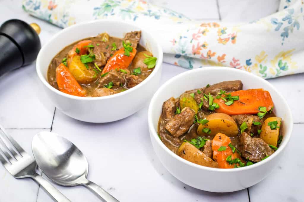 Two servings of Beef Stew, showcasing vibrant carrots and potatoes in a rich, savory broth.