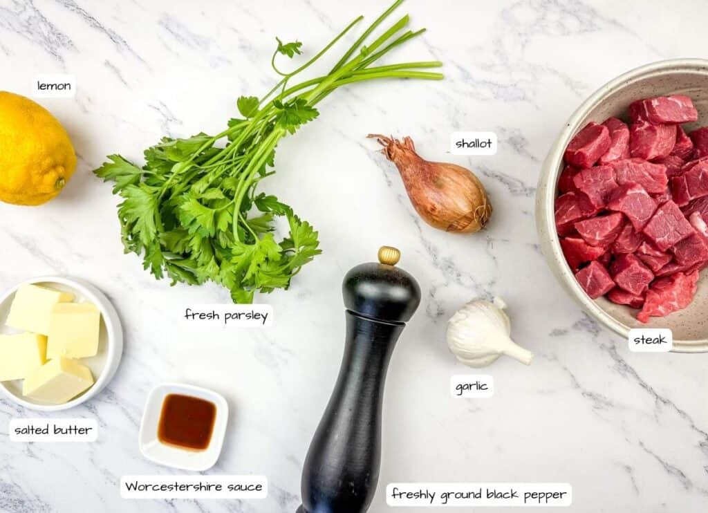 Garlic Butter Steak Bites Escargot-Style ingredients on a table with label.
