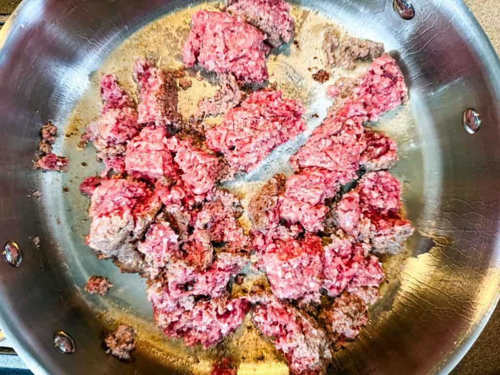 Crumbles of ground beef in a large skillet.