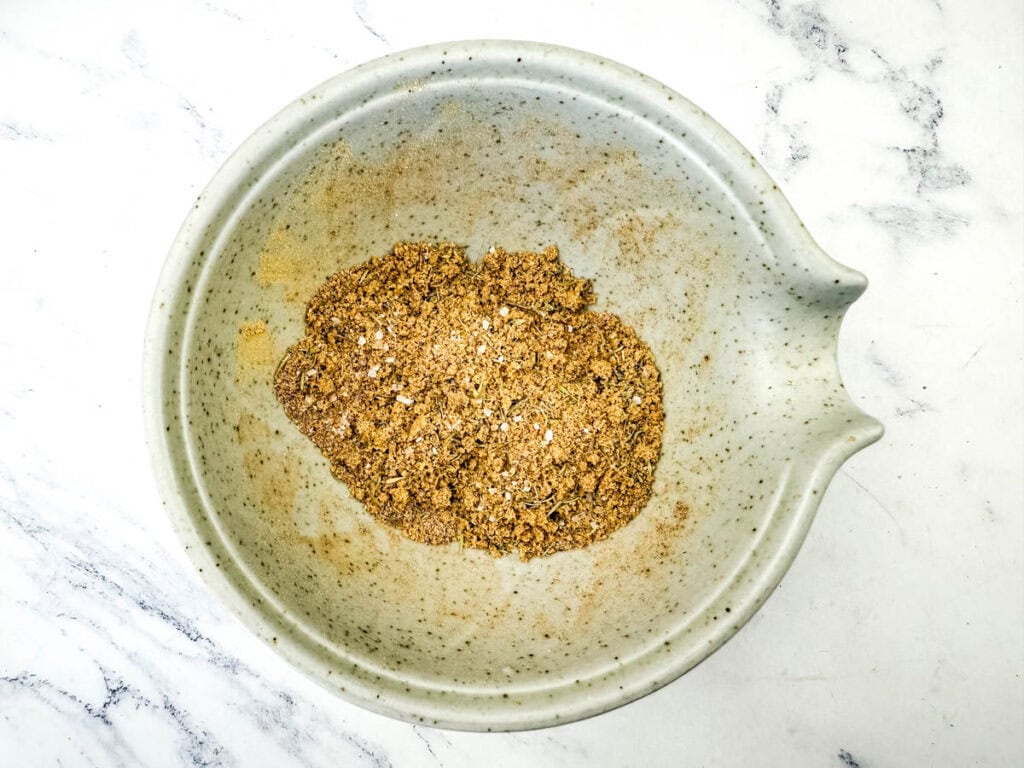 Brown sugar, thyme, salt, black pepper, cinnamon, nutmeg, ginger, and cayenne together in a small bowl.