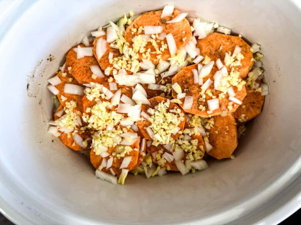 Chopped onion, garlic, and ginger over the sweet potatoes.